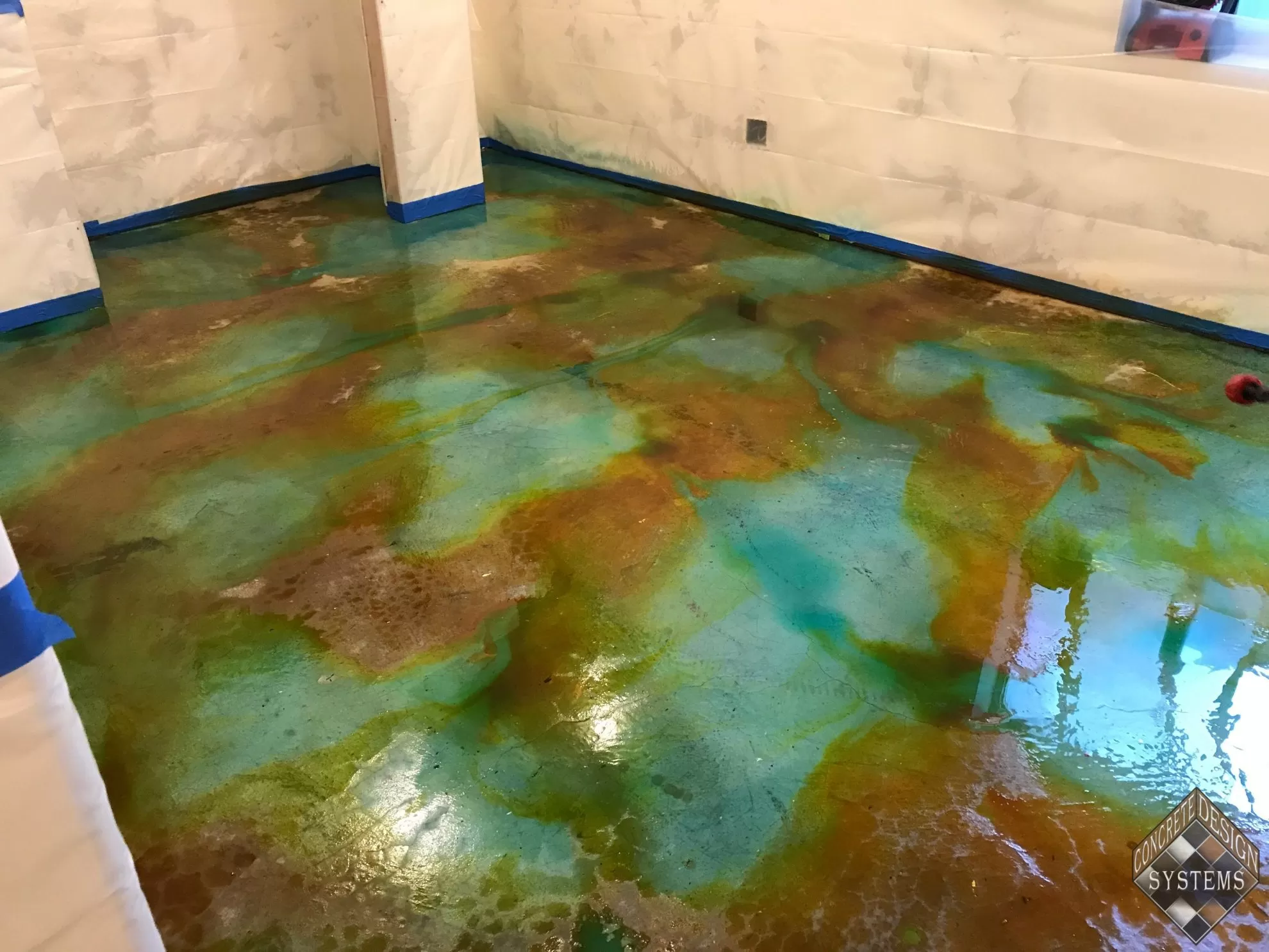 Ebony and Turquoise Acid Stained Basement Service, Stained Basement Floor